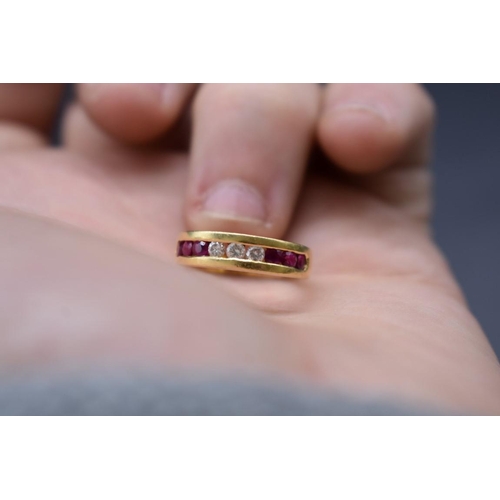 74 - A yellow metal diamond and ruby half eternity ring, stamped .750, size I 1/2.