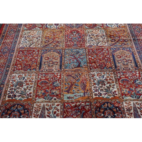 1076 - A Persian rug, having trees, birds and flowers to central field, 222 x 157cm.