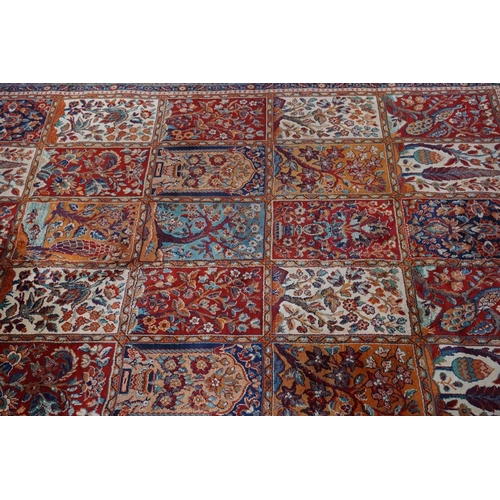 1076 - A Persian rug, having trees, birds and flowers to central field, 222 x 157cm.