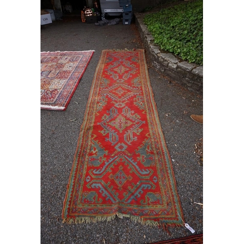 1077 - A Persian runner, having five central medallions on a red ground, 350 x 96cm. 