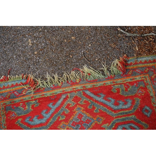 1077 - A Persian runner, having five central medallions on a red ground, 350 x 96cm. 