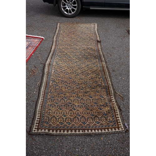 1079 - A Persian runner, having repeated design to central field, 323 x 107cm.