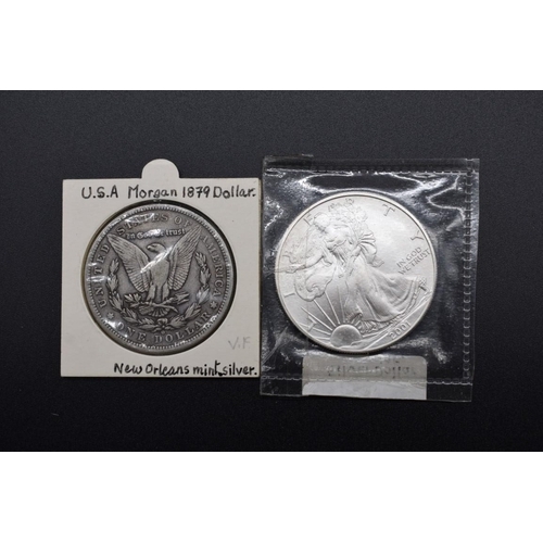 140 - Coins: a US 1879 Morgan silver dollar, New Orleans Mint; together with a US 2001 Liberty Eagle dolla... 