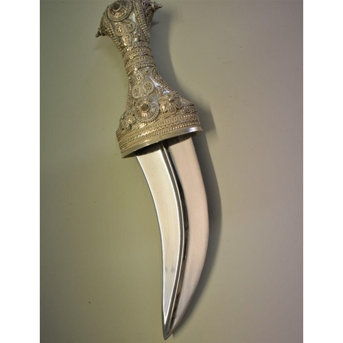 1787 - A modern Arab jambiya and sheath, having 15cm curved blade.