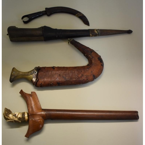 1798 - Four various eastern daggers and scabbards, comprising: an Indonesian Kris, having 26cm bl... 