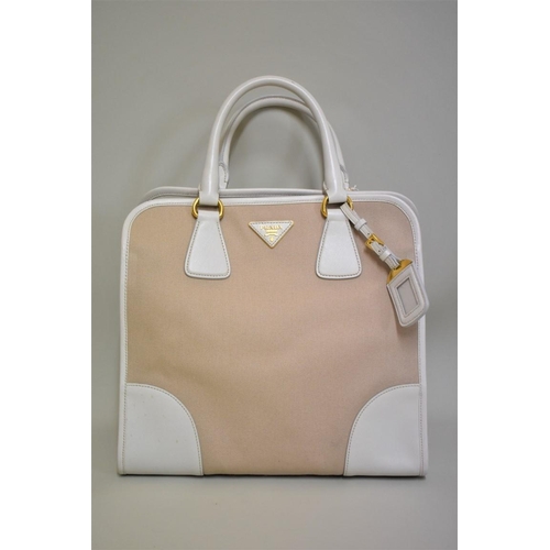 1810 - Prada: a large beige canvas and leather handbag with gilt hardware and detachable webbing shoulder s... 