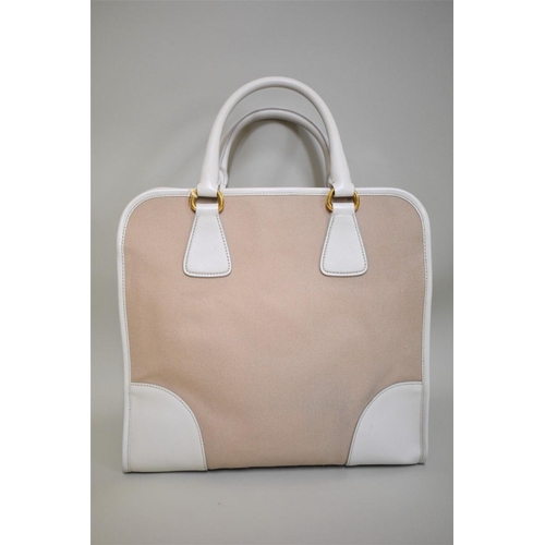 1810 - Prada: a large beige canvas and leather handbag with gilt hardware and detachable webbing shoulder s... 