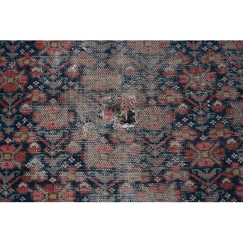 1076a - A North West Persian rug, having repeated floral decoration to central field with floral borders, 32... 