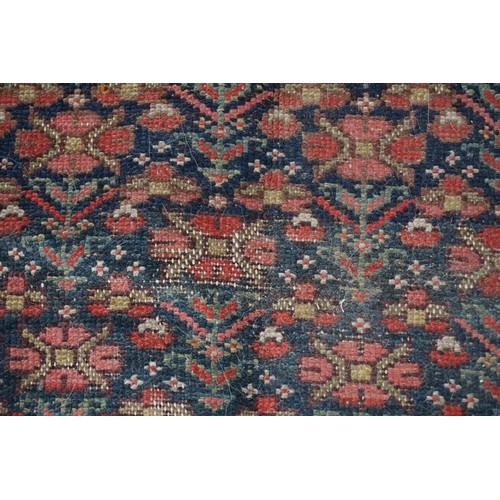 1076a - A North West Persian rug, having repeated floral decoration to central field with floral borders, 32... 