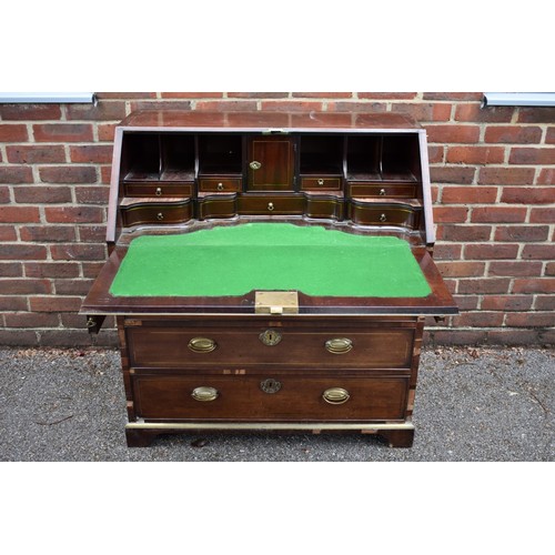 1086 - An unusual George III mahogany and brass inlaid bureau, in the manner of John Channon, the fall encl... 