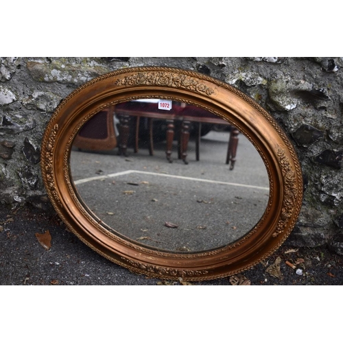 1072 - A gilt framed oval wall mirror, 71 x 60cm, (some chipping to gilt decoration). Collection of this lo... 