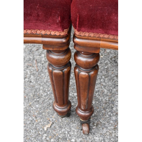 1073 - A set of four red upholstered dining chairs. Collection of this lot is strictly by appointment on Sa... 