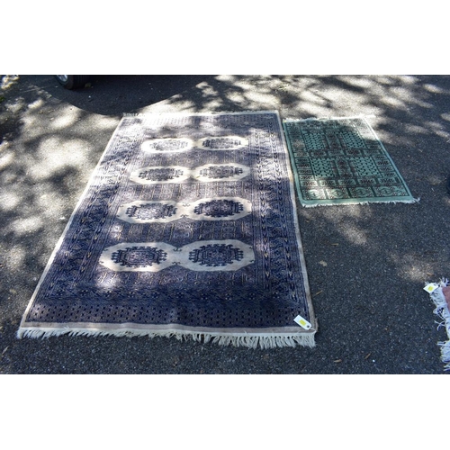 1101 - A Persian Bokhara rug, 107 x 125cm; together with a smaller example, 93 x 63cm.