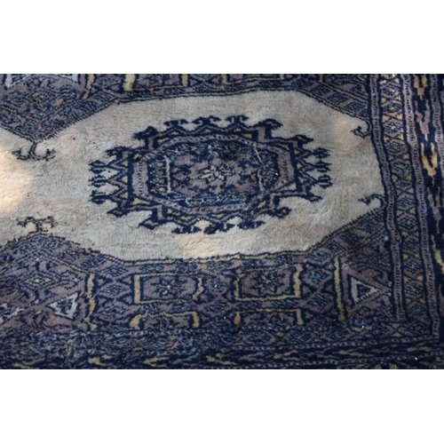 1101 - A Persian Bokhara rug, 107 x 125cm; together with a smaller example, 93 x 63cm.