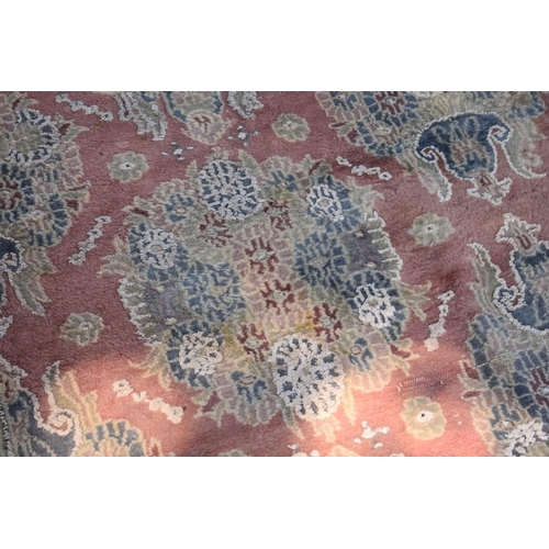 1102 - A Persian style carpet, having floral and geometric borders on a pink ground, 266 x 190cm.... 