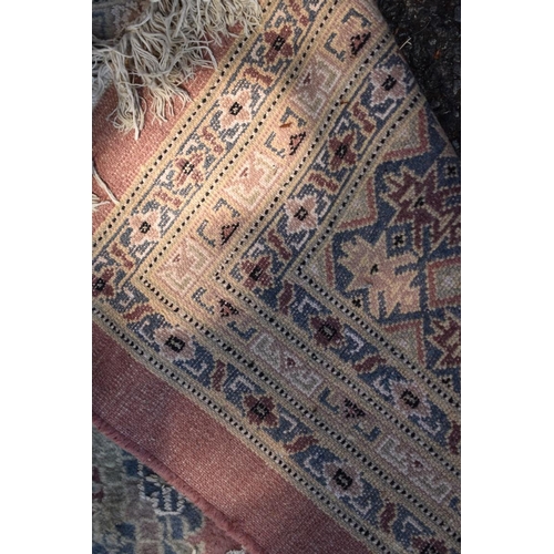 1102 - A Persian style carpet, having floral and geometric borders on a pink ground, 266 x 190cm.... 