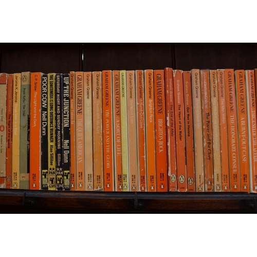 467 - PENGUINS: a collection of 70 Penguin editions of novels by Graham Greene, plus 60 other vintage... 