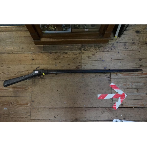 1700 - An antique percussion musket; together with an antique Indian matchlock musket.