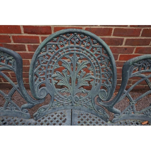 1010A - A green painted cast iron garden bench, 136cm wide.