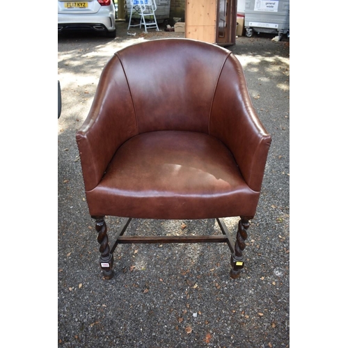 1060 - A 1920s oak and leather desk chair. 