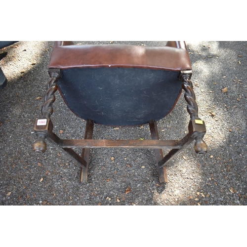 1060 - A 1920s oak and leather desk chair. 