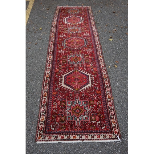 1100a - A Persian runner, having seven central medallions, the central field decorated with flowers, 280 x 8... 