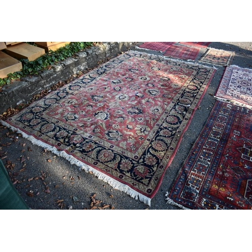 1101 - A floral rug, central field decorated with flowers and deer, with floral borders.
