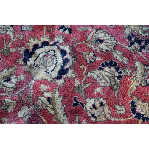 1101 - A floral rug, central field decorated with flowers and deer, with floral borders.