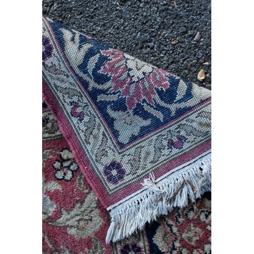 1101 - A floral rug, central field decorated with flowers and deer, with floral borders.