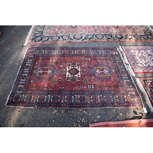 1102 - A Tribal rug, having three central medallions with geometric borders, 175 x 122cm.
