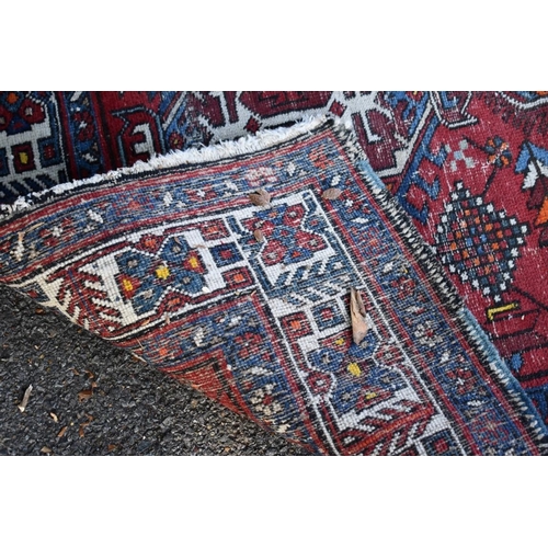 1102 - A Tribal rug, having three central medallions with geometric borders, 175 x 122cm.