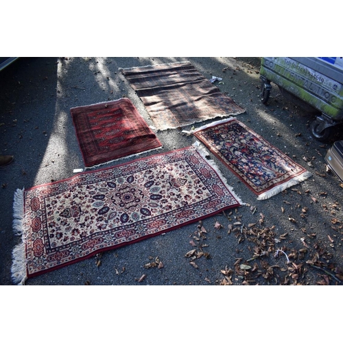 1103 - An Afghan rug, having allover geometric design; together with a small Bokhara rug and two other smal... 