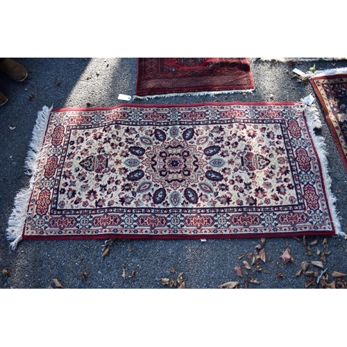 1103 - An Afghan rug, having allover geometric design; together with a small Bokhara rug and two other smal... 
