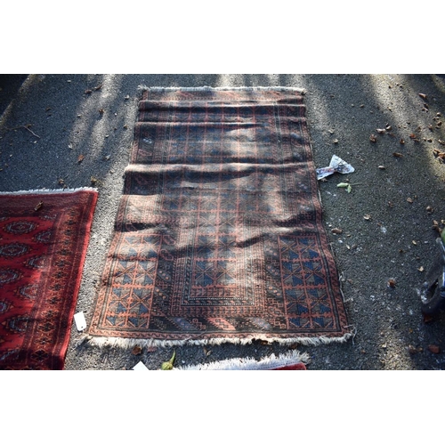 1103 - An Afghan rug, having allover geometric design; together with a small Bokhara rug and two other smal... 