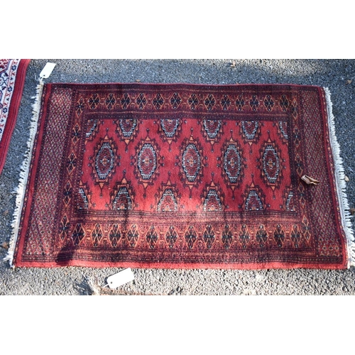 1103 - An Afghan rug, having allover geometric design; together with a small Bokhara rug and two other smal... 