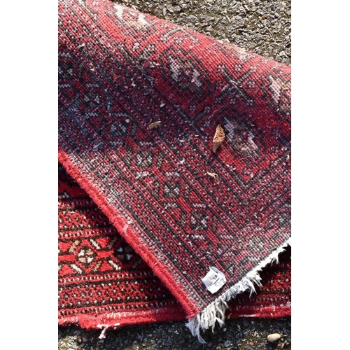 1106 - A Bokhara runner on a red ground, 262 x 56cm.
