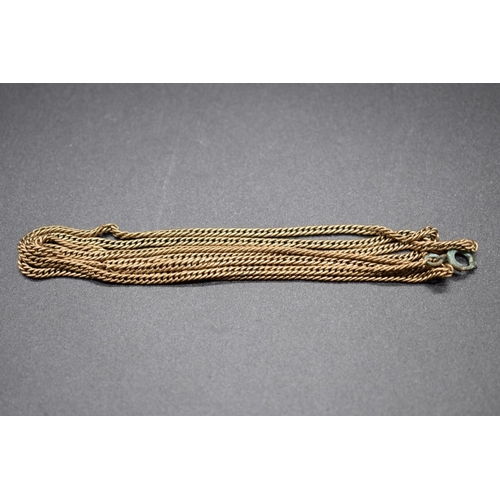 189 - A yellow metal chain, 86cm, with attached plated clasp.