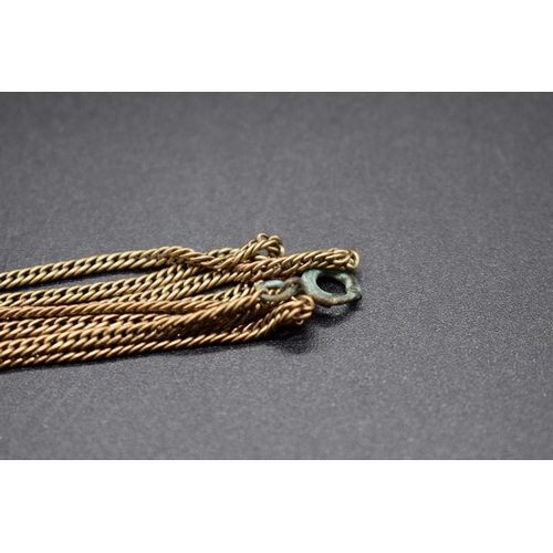 189 - A yellow metal chain, 86cm, with attached plated clasp.