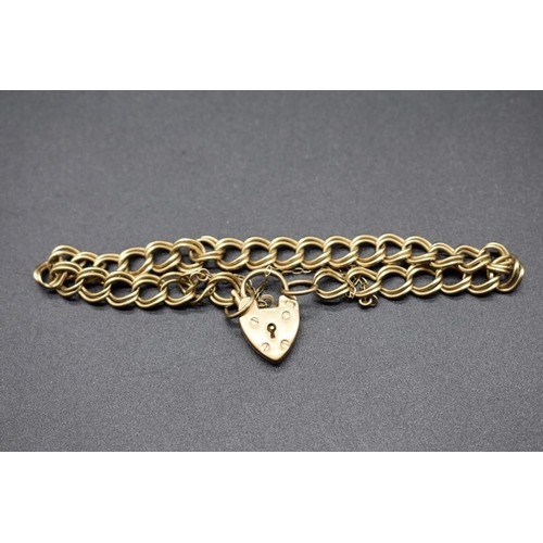 193 - A 9ct gold double curb bracelet having padlock clasp, 13.7g.