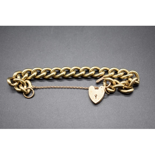 194 - A 9ct gold curb chain bracelet, stamped 375, having padlock clasp, 55g.