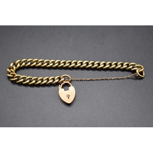 196 - A yellow metal curb link bracelet, stamped 15, with attached 15ct gold padlock clasp, gross weight 1... 