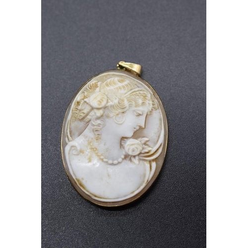 200 - A yellow metal framed carved shell cameo pendant, stamped 9ct, 3.9cm.