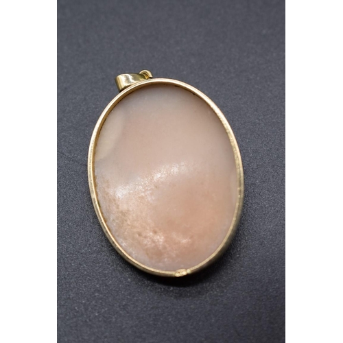 200 - A yellow metal framed carved shell cameo pendant, stamped 9ct, 3.9cm.