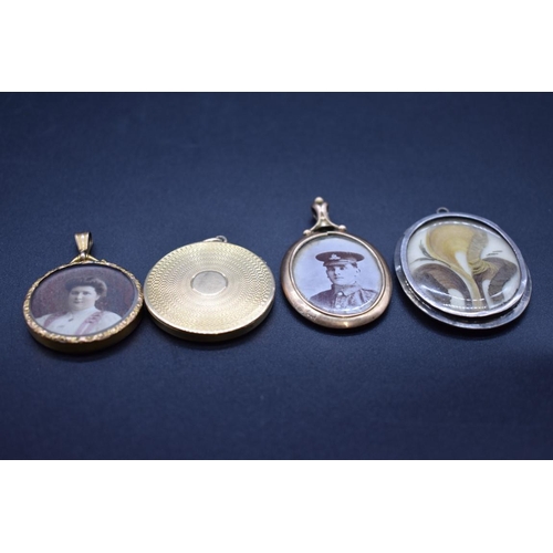 203 - Two portrait pendants having yellow metal frames, stamped 9ct; together with another engine turned y... 