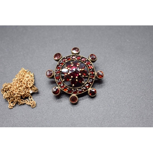 207 - An Art Deco paste brooch, 70mm; together with a Victorian garnet set floral brooch, 30mm; and a plat... 