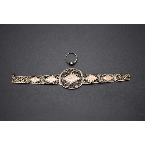 208 - A 1930s Egyptian yellow and white metal filigree bracelet, having triangular panels decorated pyrami... 