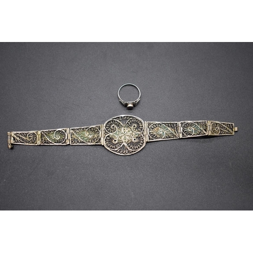 208 - A 1930s Egyptian yellow and white metal filigree bracelet, having triangular panels decorated pyrami... 