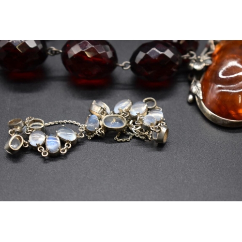 223 - A graduated and faceted cherry amber bead necklace, 43cm, 49g; together with an amber pendant, on ch... 