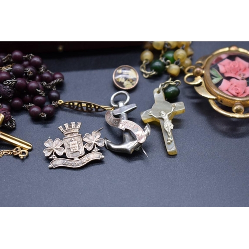 228 - A yellow metal crucifix, set cabochon garnet, on 9ct gold fine chain; together with a 'Baby' brooch,... 