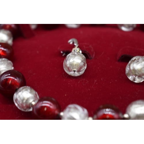 239 - A contemporary chunky foiled red and clear glass bead necklace and matching earrings, the necklace 4... 